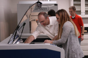 In this 2017 photo, chemical engineering associate professor (lecturer) Tony Butterfield works with students in the Meldrum Innovation Laboratory in the Merrill Engineering Building.