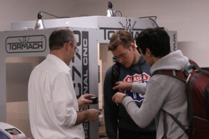 In this 2017 photo, chemical engineering associate professor (lecturer) Tony Butterfield works with students in the Meldrum Innovation Laboratory in the Merrill Engineering Building. The state-of-the-art lab is outfitted with the latest technology to aid students including 3D printers and laser cutters.