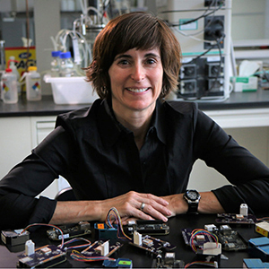 Chemical engineering assistant professor Kerry E. Kelly with prototypes of a portable air quality sensors she has helped design.