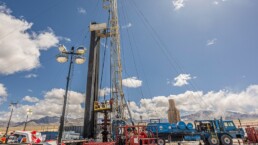 Photo of the Utah Forge. It is a tall metal construct securedby wires