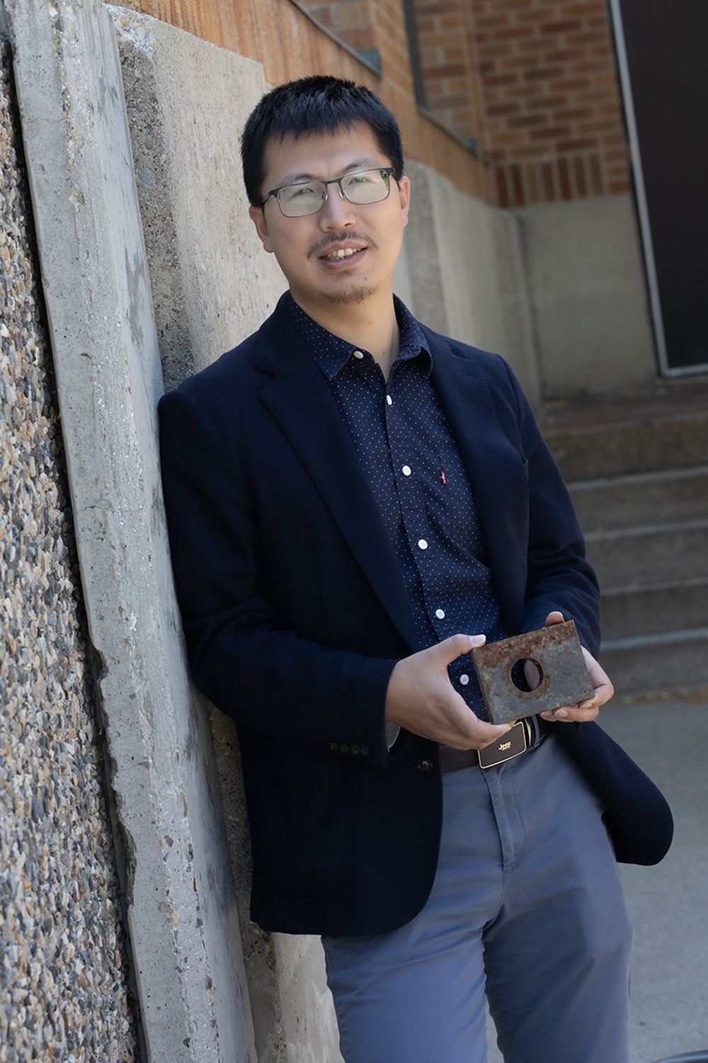 Tao Gao holding a block of iron